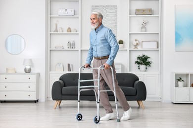 Photo of Senior man using walking frame at home