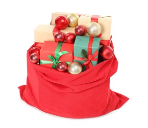 Photo of Santa Claus bag full of presents and decorative balls isolated on white