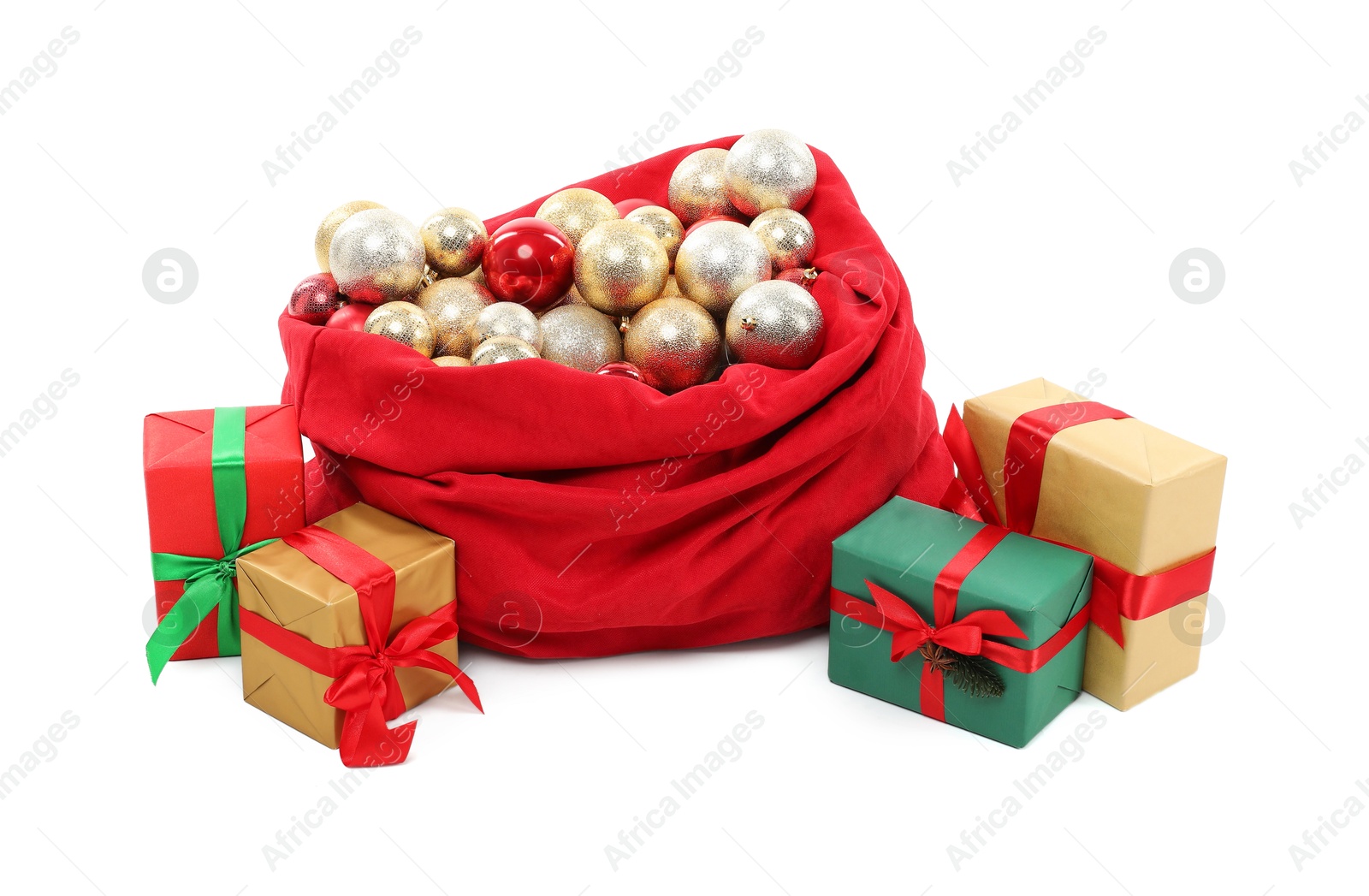 Photo of Red Santa Claus bag with baubles and gift boxes isolated on white