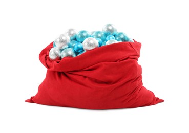 Photo of Red Santa Claus bag with baubles isolated on white