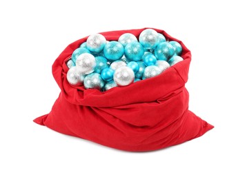 Photo of Red Santa Claus bag with baubles isolated on white