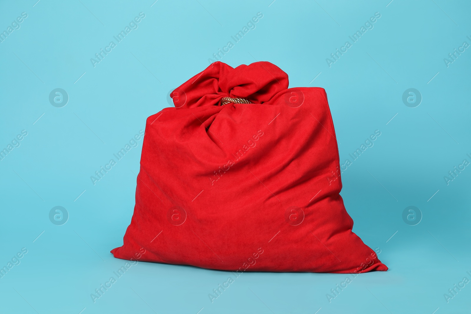 Photo of One Santa Claus bag on light blue background