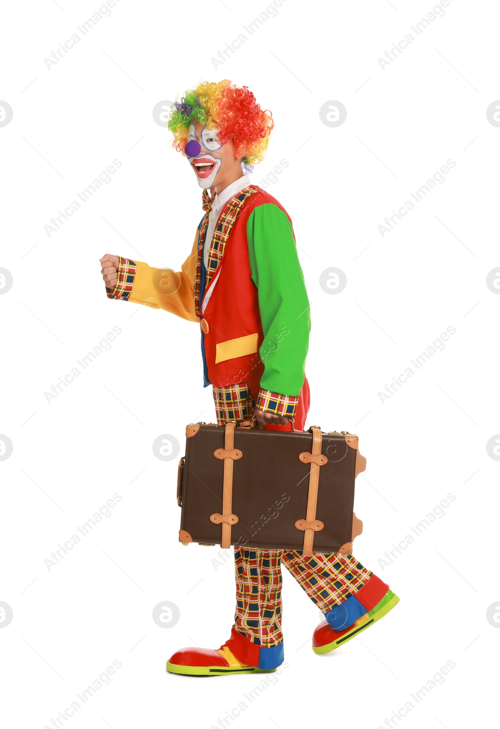 Photo of Happy clown with suitcase on white background