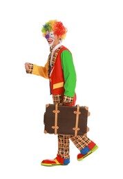 Photo of Happy clown with suitcase on white background