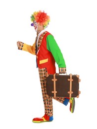 Photo of Happy clown with suitcase on white background