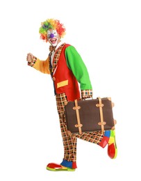 Photo of Happy clown with suitcase on white background