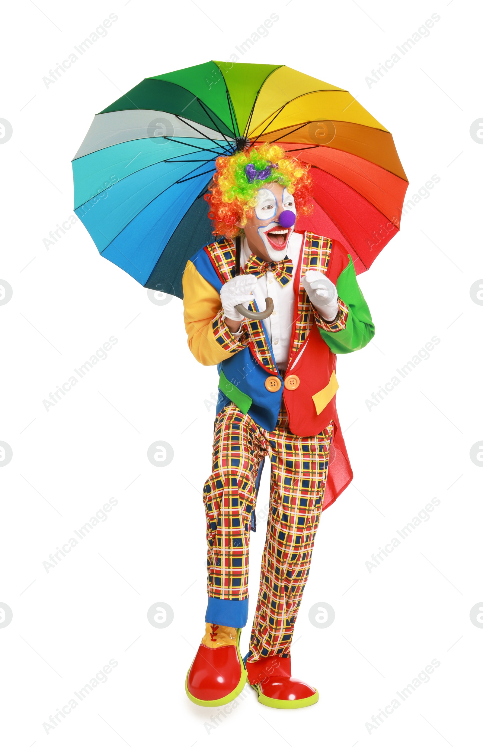 Photo of Happy clown with colorful umbrella on white background