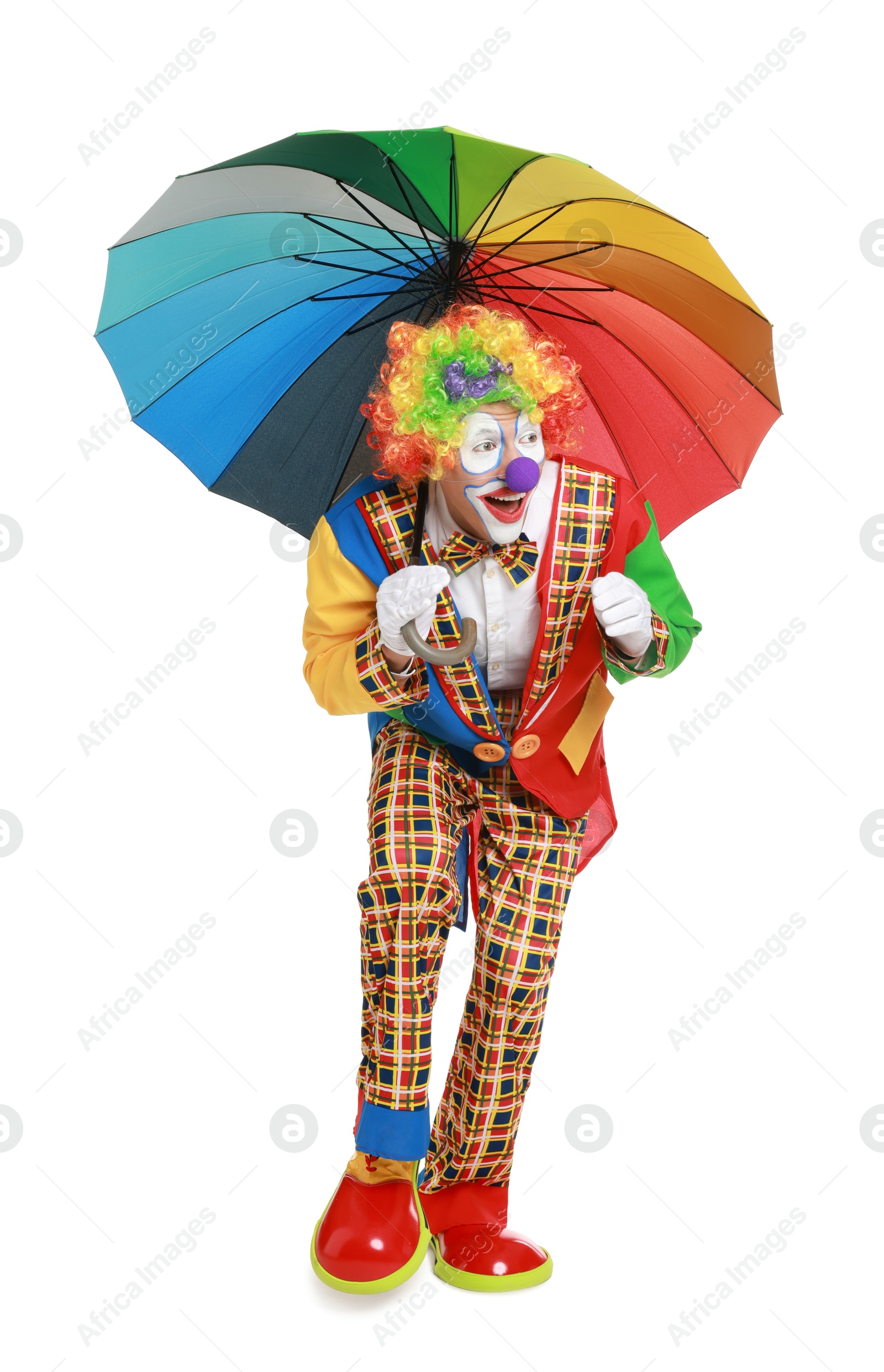 Photo of Happy clown with colorful umbrella on white background