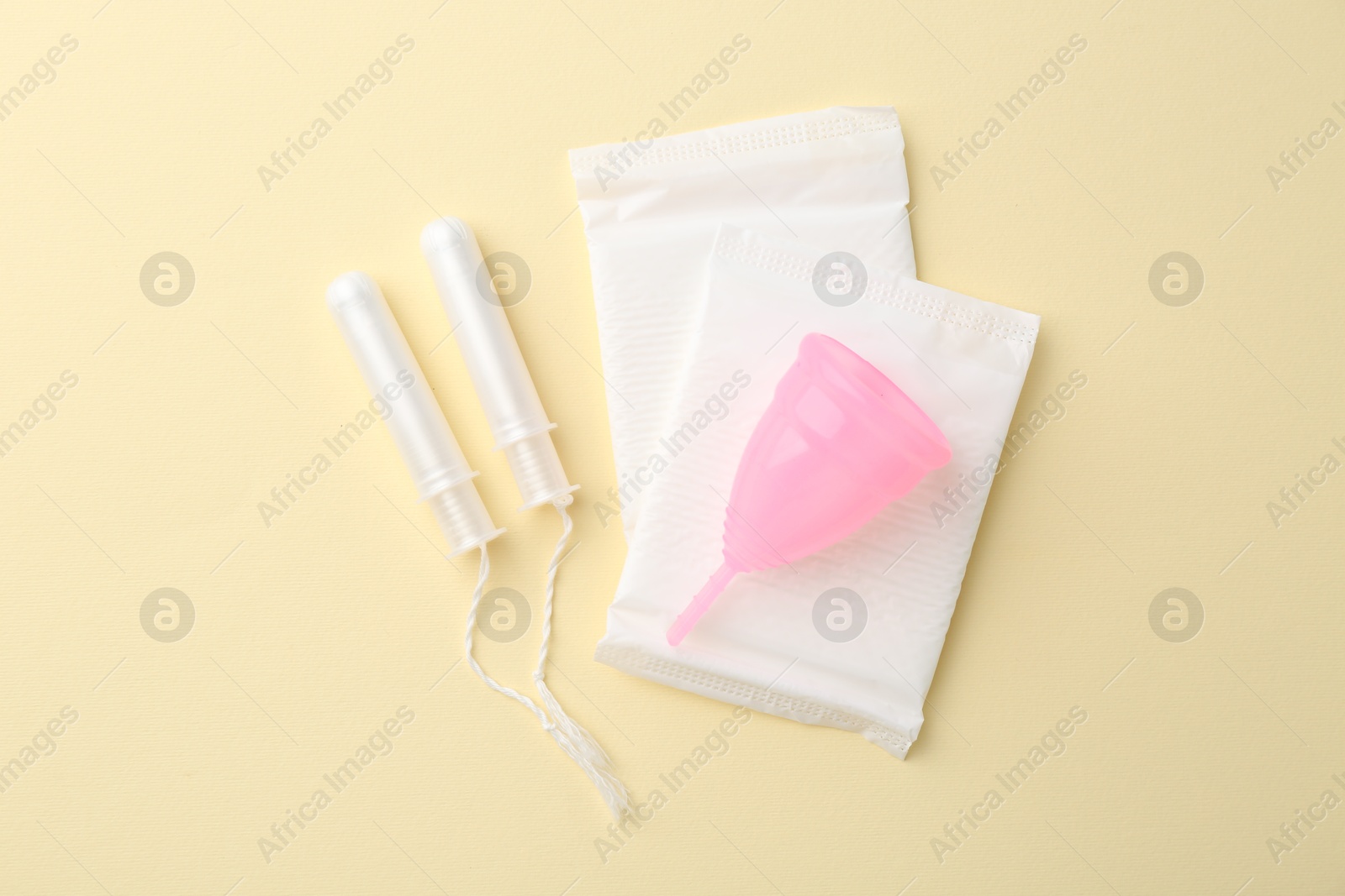 Photo of Flat lay composition with menstrual products on beige background