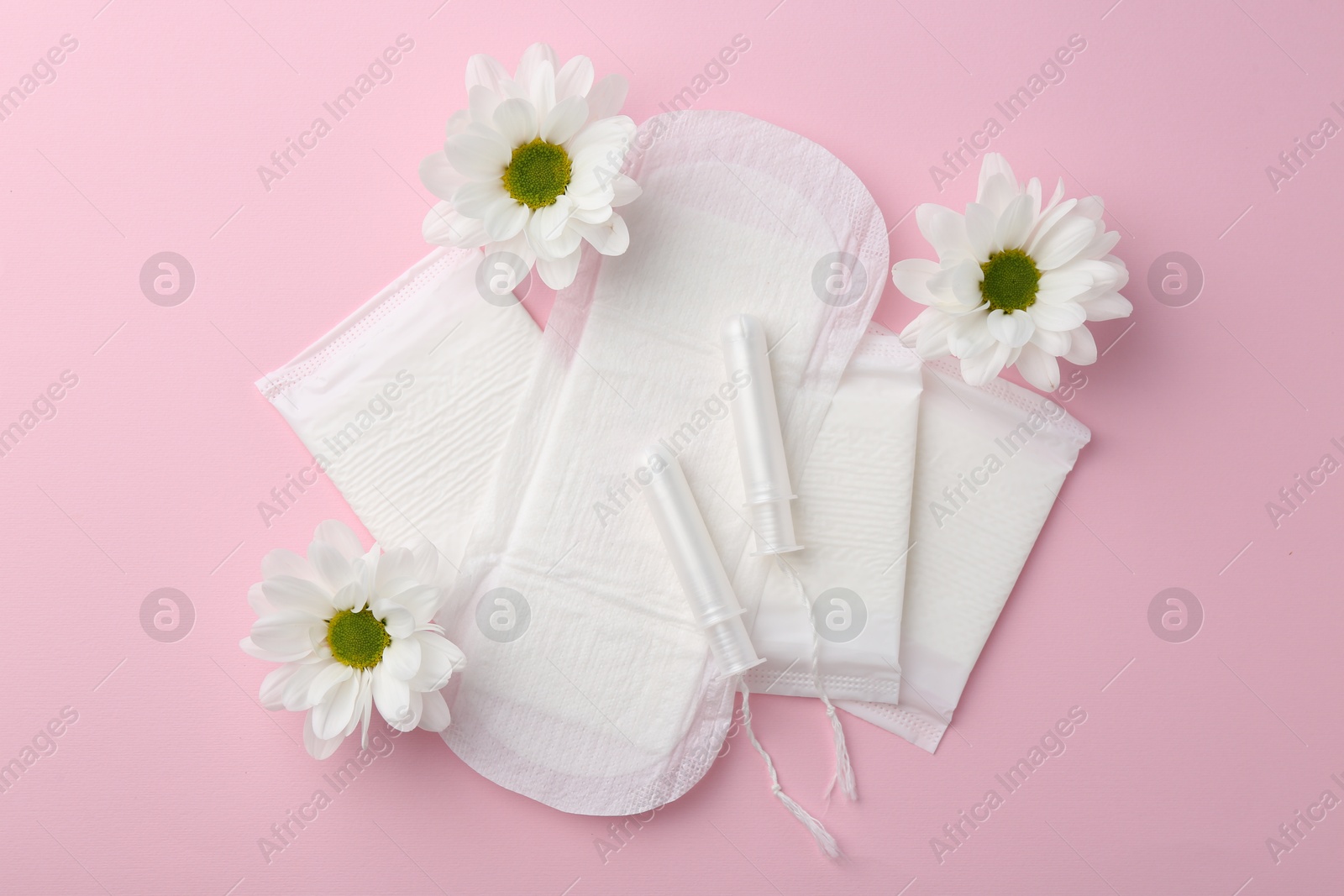 Photo of Flat lay composition with menstrual products on pink background