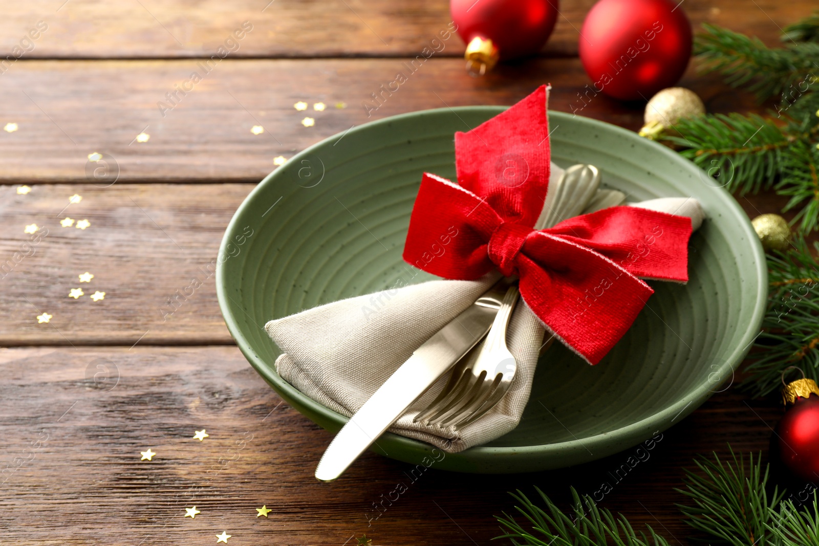 Photo of Christmas setting and festive decor on wooden table, closeup. Space for text