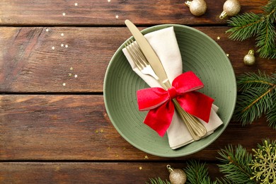 Photo of Christmas setting and festive decor on wooden table, flat lay. Space for text