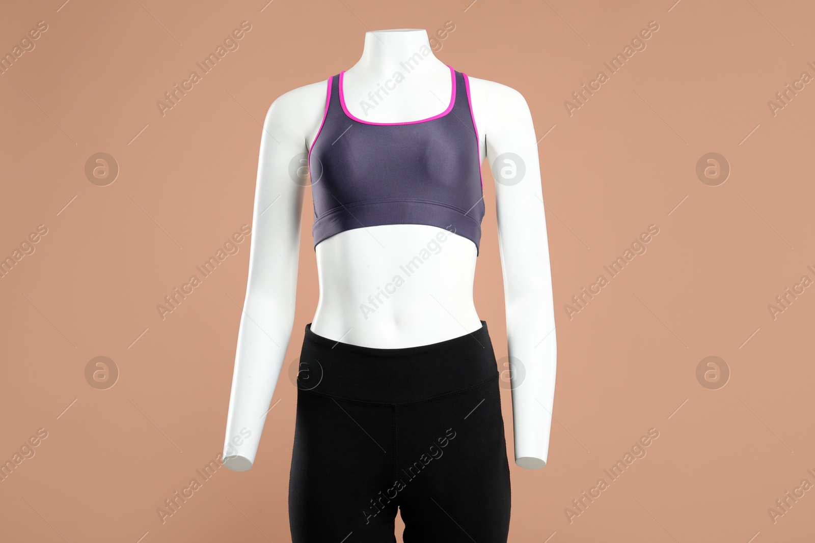 Photo of Female mannequin with stylish sportswear on beige background