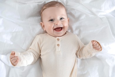 Cute little baby on bed indoors, top view