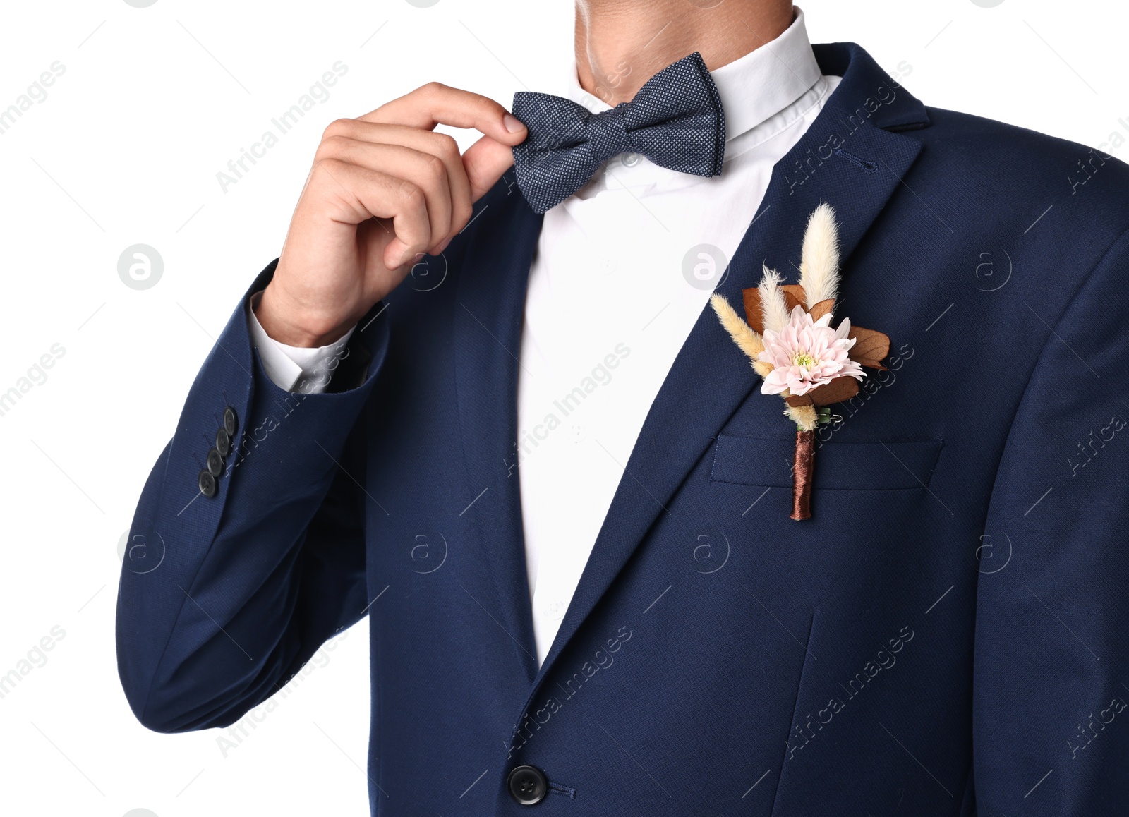 Photo of Groom in suit with stylish boutonniere on white background, closeup