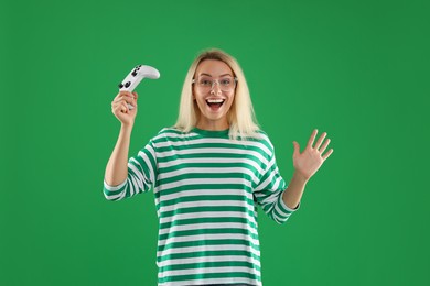 Happy woman with controller on green background