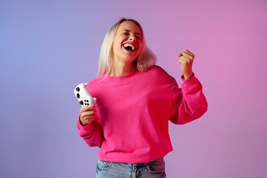 Happy woman with controller on color background