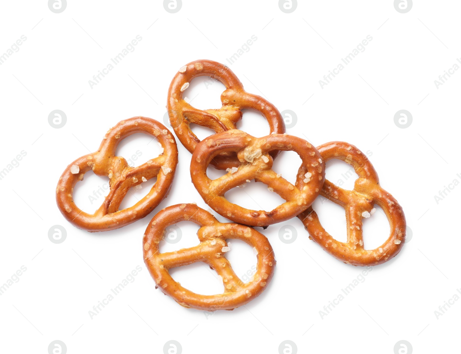 Photo of Many delicious pretzel crackers isolated on white, top view