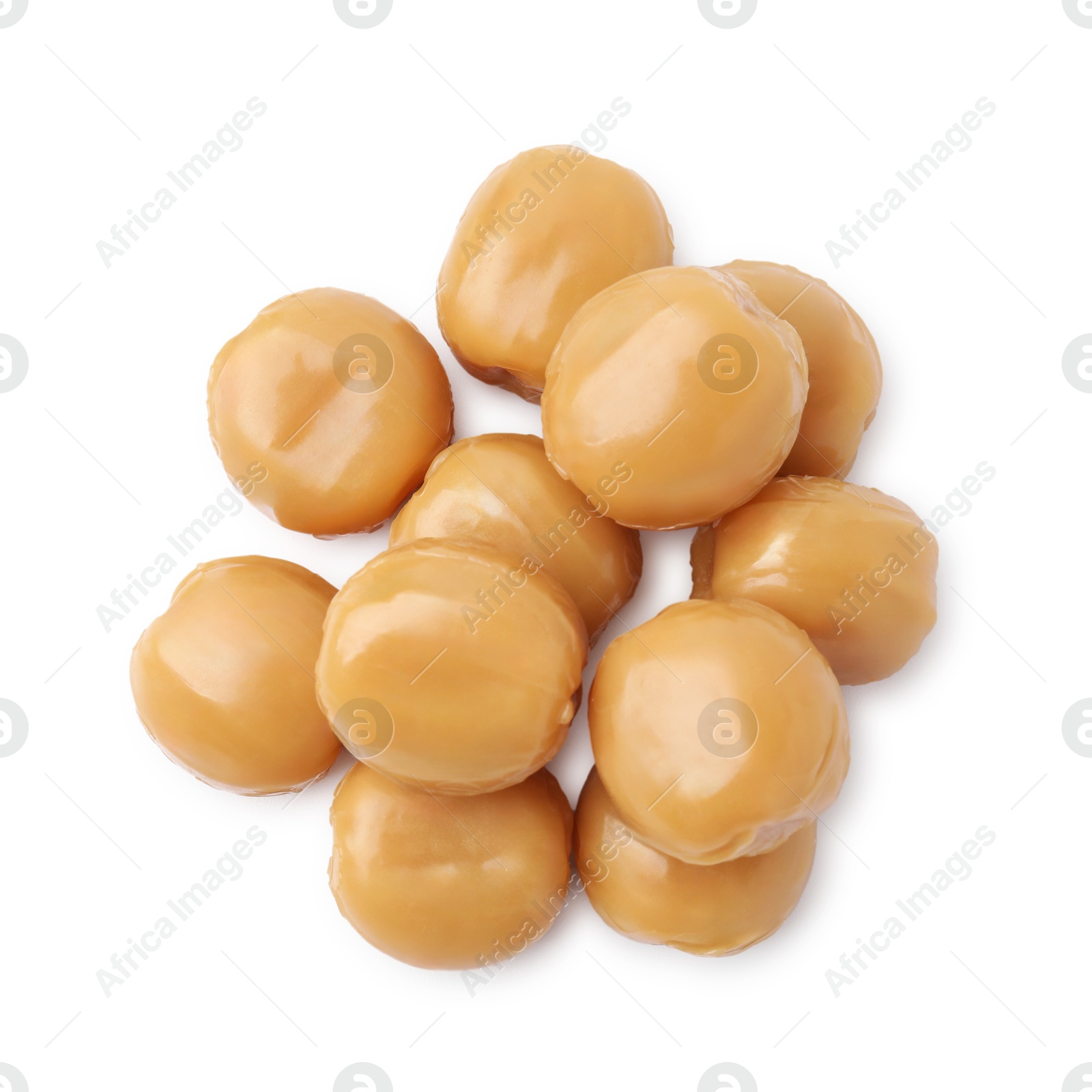 Photo of Tasty hard toffee candies isolated on white, top view