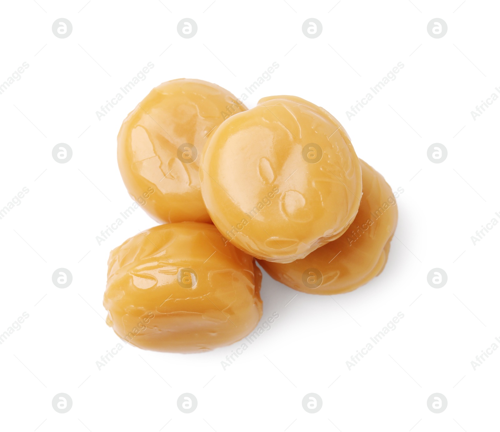 Photo of Tasty hard toffee candies isolated on white, top view