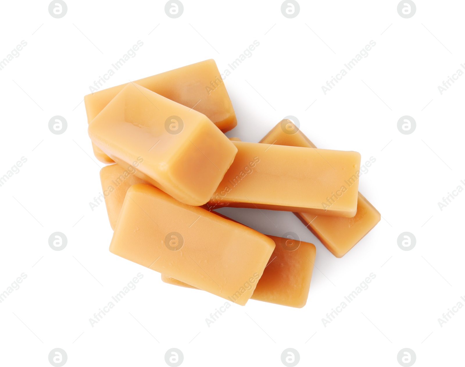 Photo of Tasty sweet caramel candies isolated on white, top view