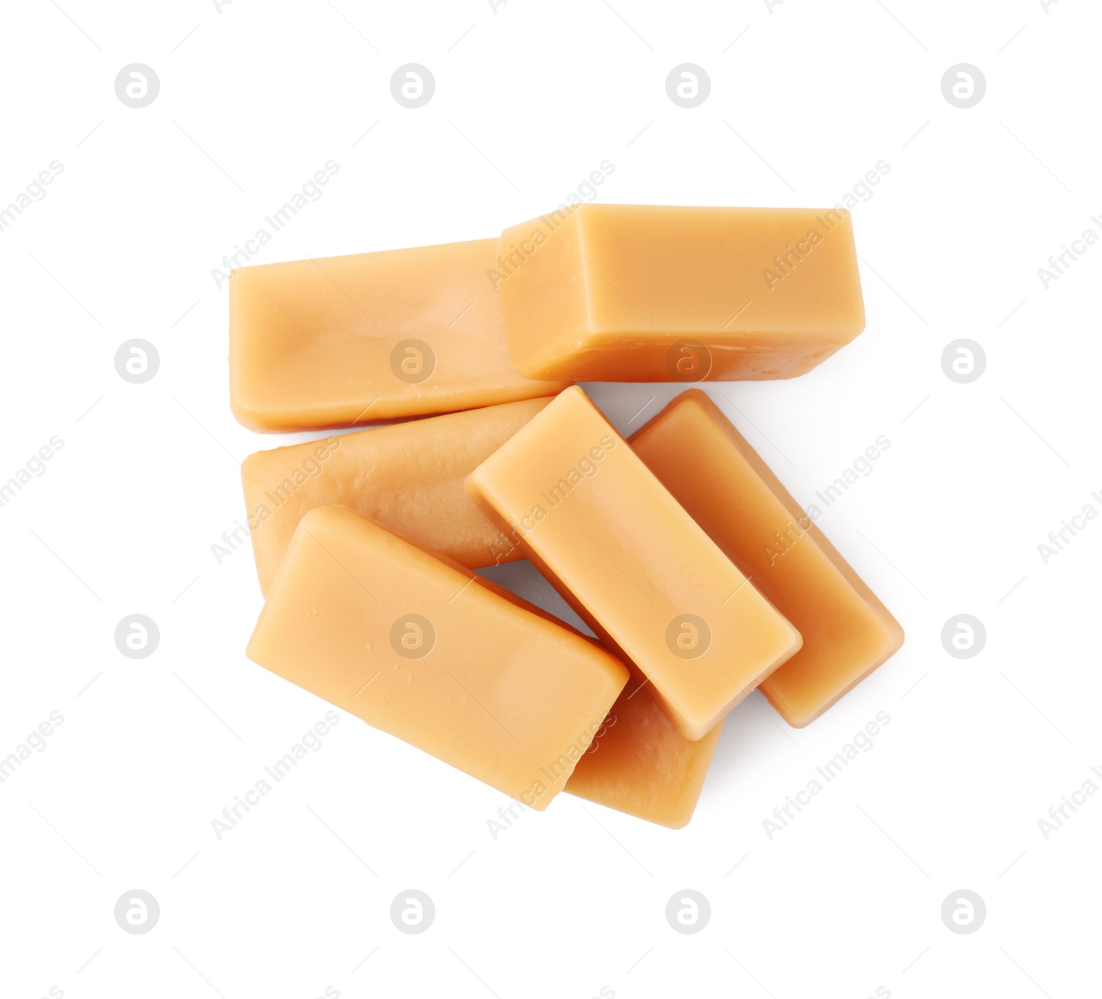 Photo of Tasty sweet caramel candies isolated on white, top view