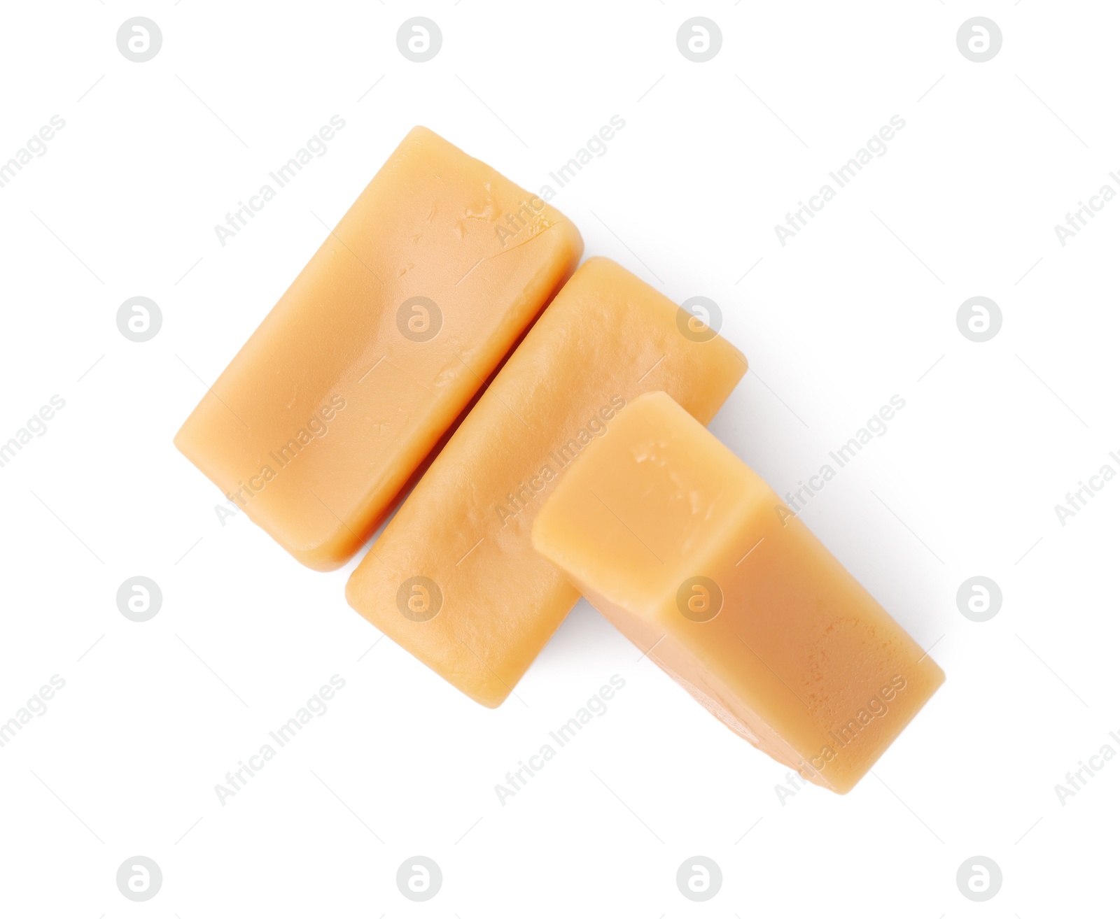 Photo of Tasty sweet caramel candies isolated on white, top view