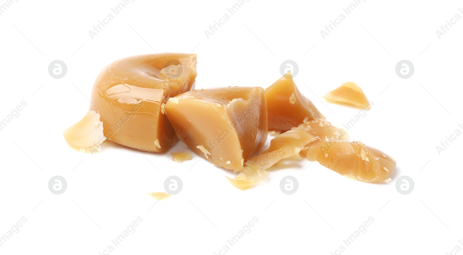 Photo of Pieces of tasty hard toffee candy isolated on white