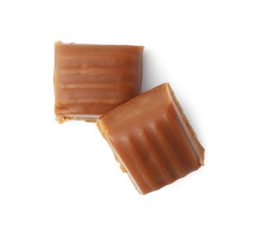 Photo of Tasty sweet caramel candies isolated on white, top view