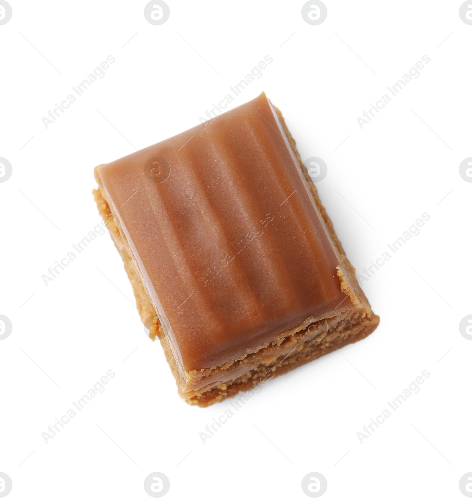 Photo of Tasty sweet caramel candy isolated on white, top view