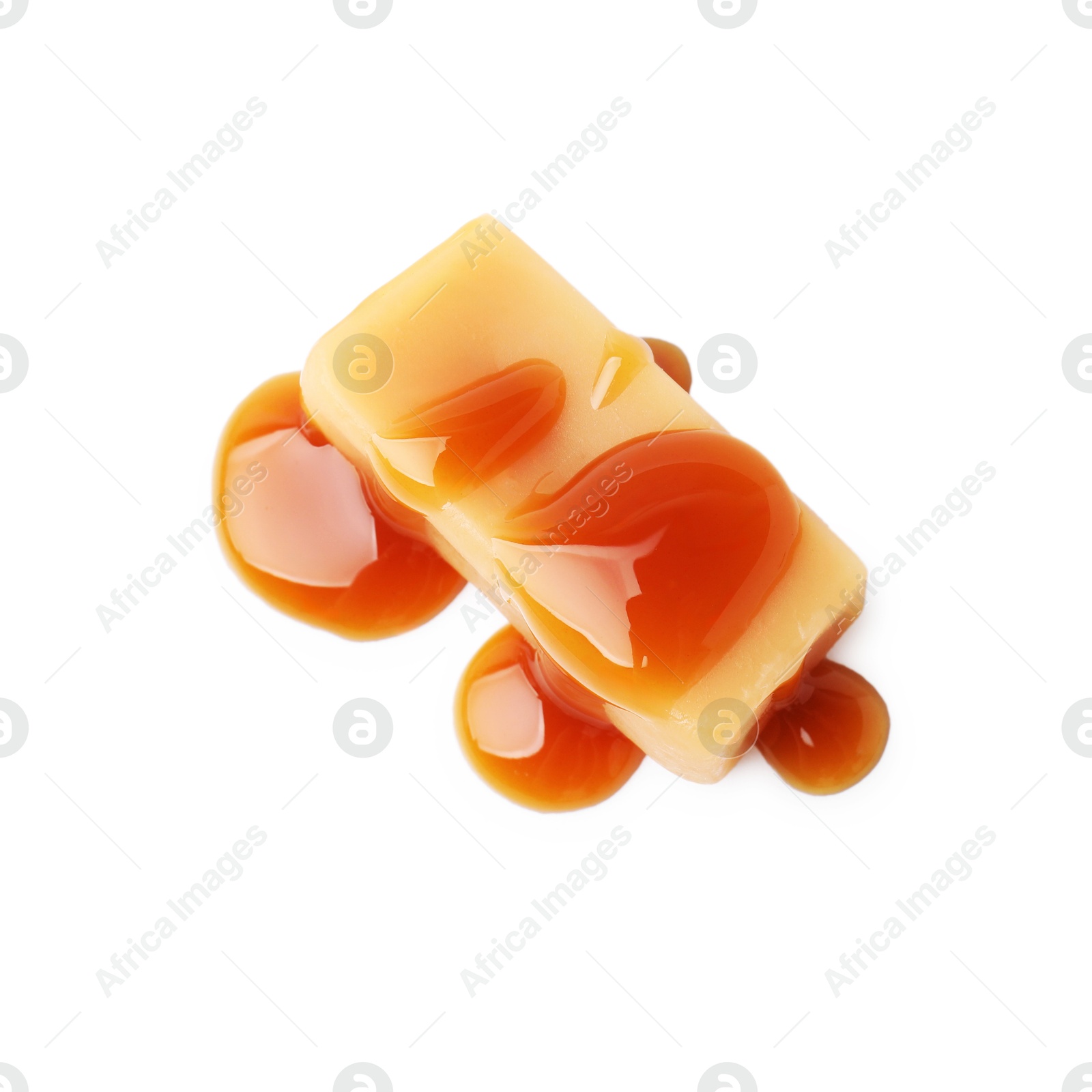 Photo of Tasty candy with caramel sauce isolated on white, top view