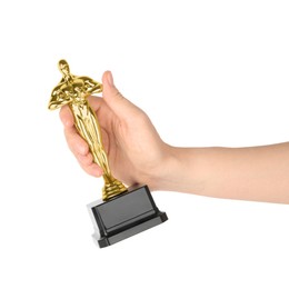 Photo of Woman holding golden trophy in shape of human figure against white background, closeup