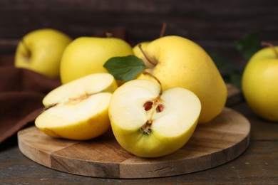 Photo of Fresh ripe yellow apples on wooden table, closeup