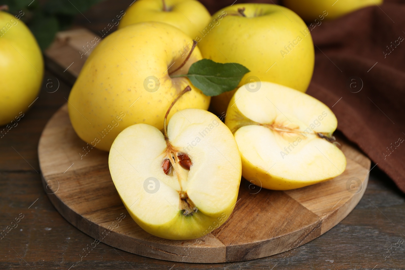 Photo of Fresh ripe yellow apples on wooden table, closeup