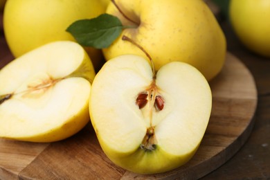 Fresh ripe yellow apples on wooden table, closeup