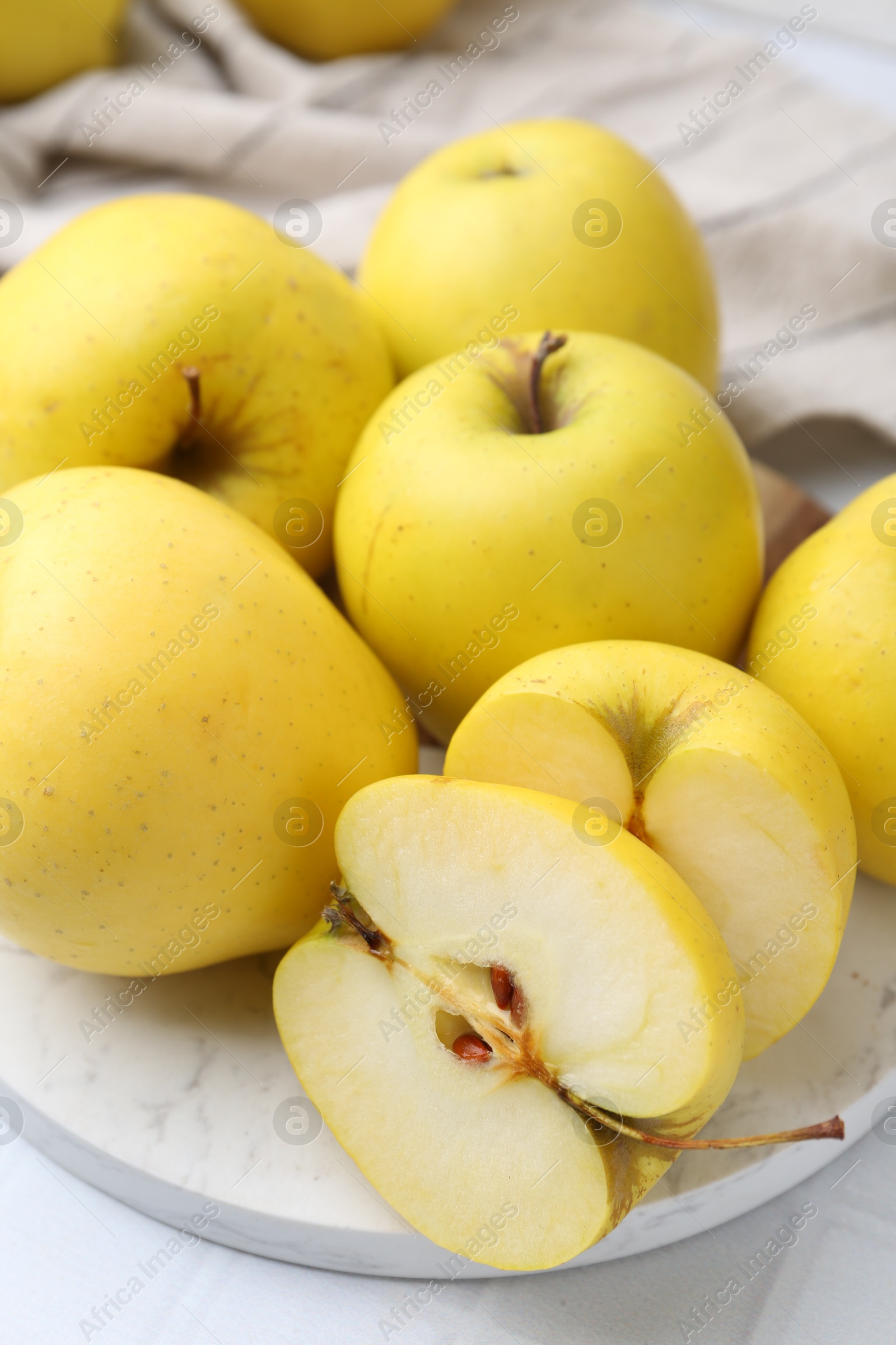 Photo of Fresh ripe yellow apples on white table, closeup