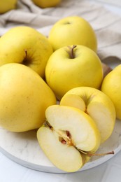 Fresh ripe yellow apples on white table, closeup