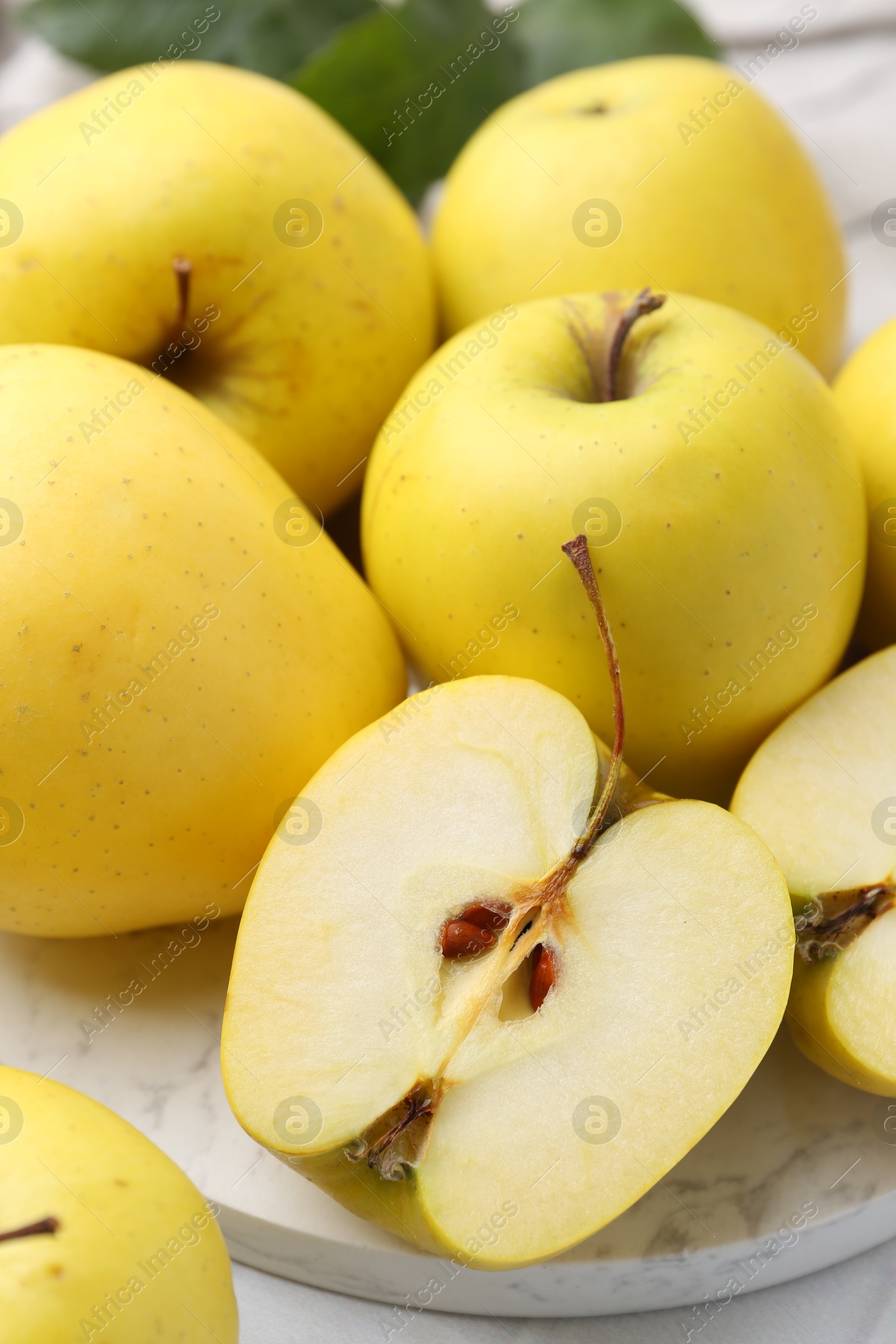 Photo of Fresh ripe yellow apples on white table, closeup