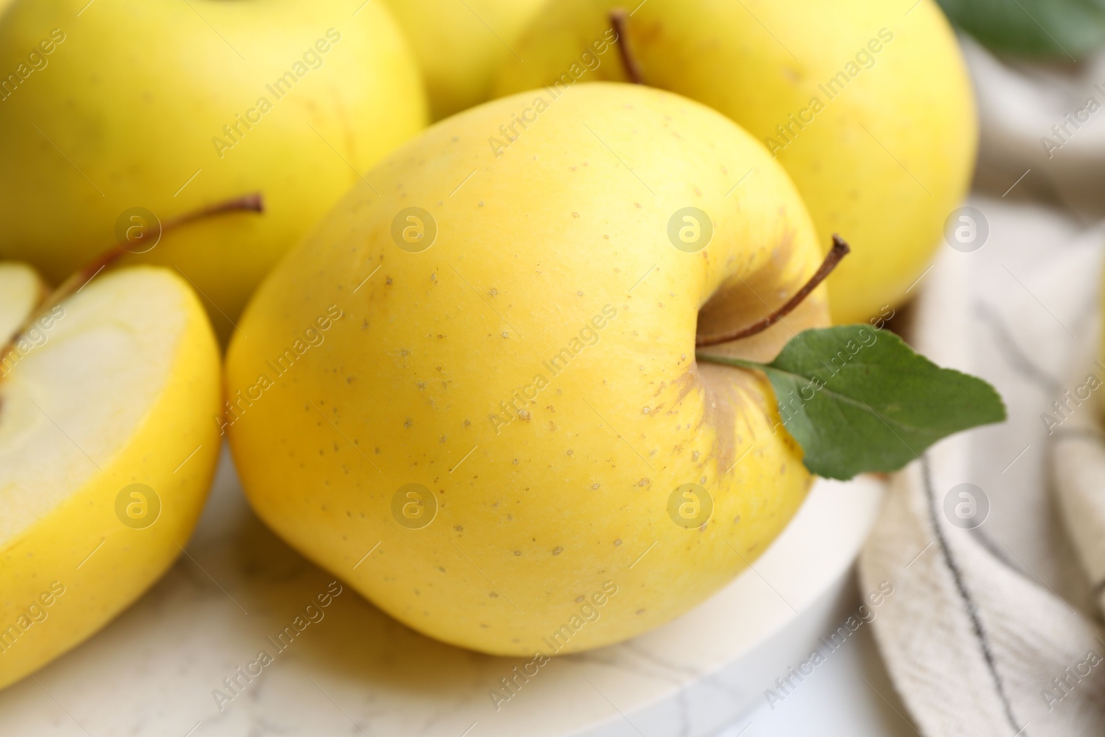 Photo of Fresh ripe yellow apples on white table, closeup