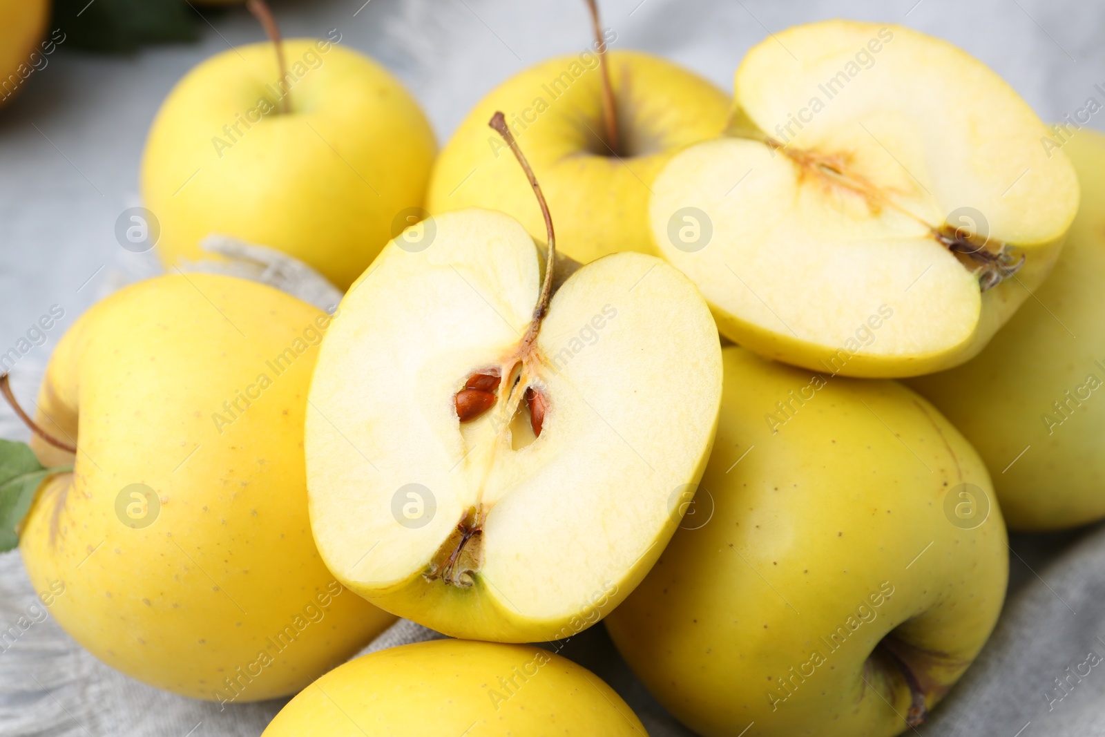 Photo of Fresh ripe yellow apples on grey table, closeup