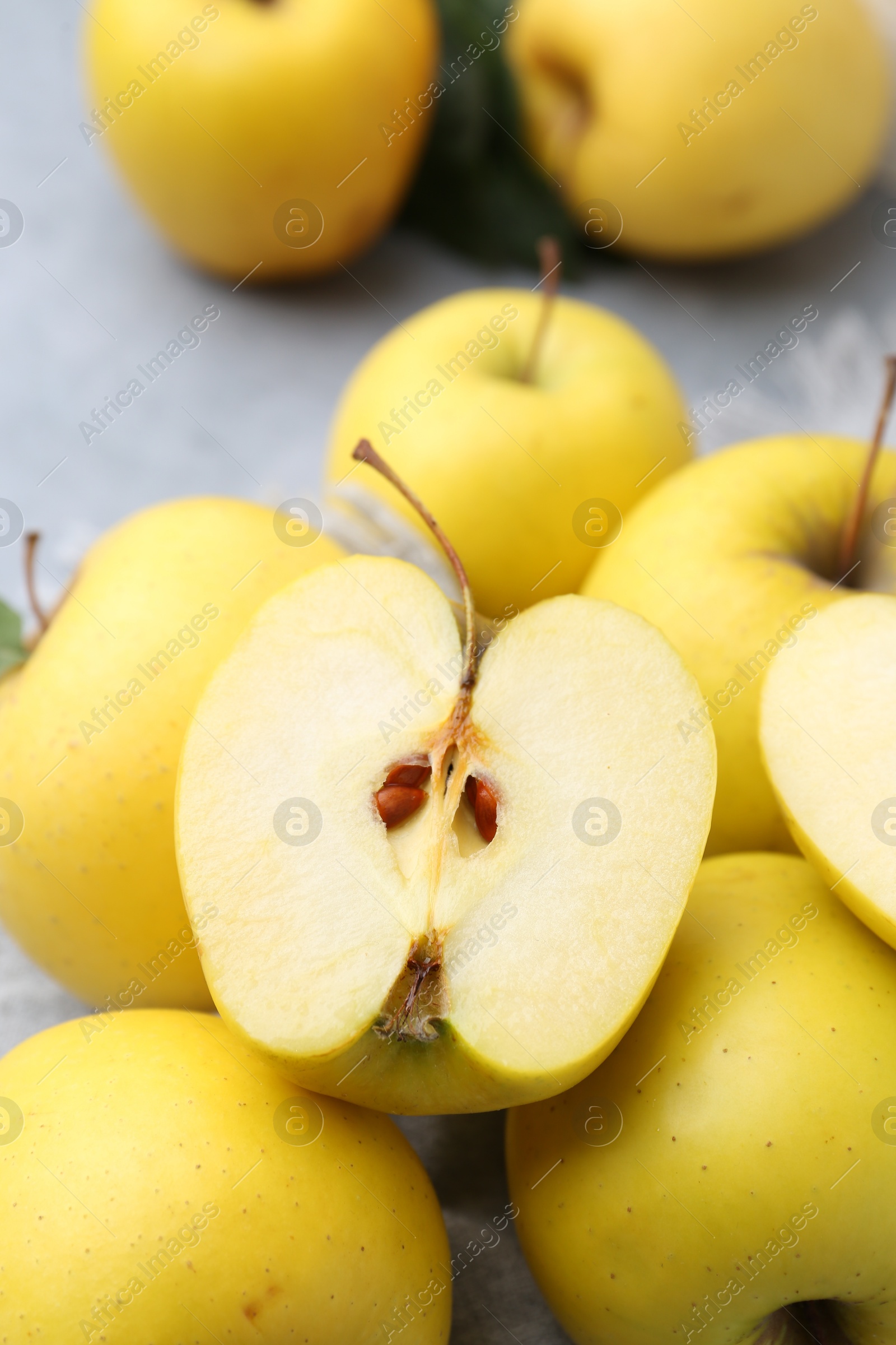 Photo of Fresh ripe yellow apples on grey table, closeup