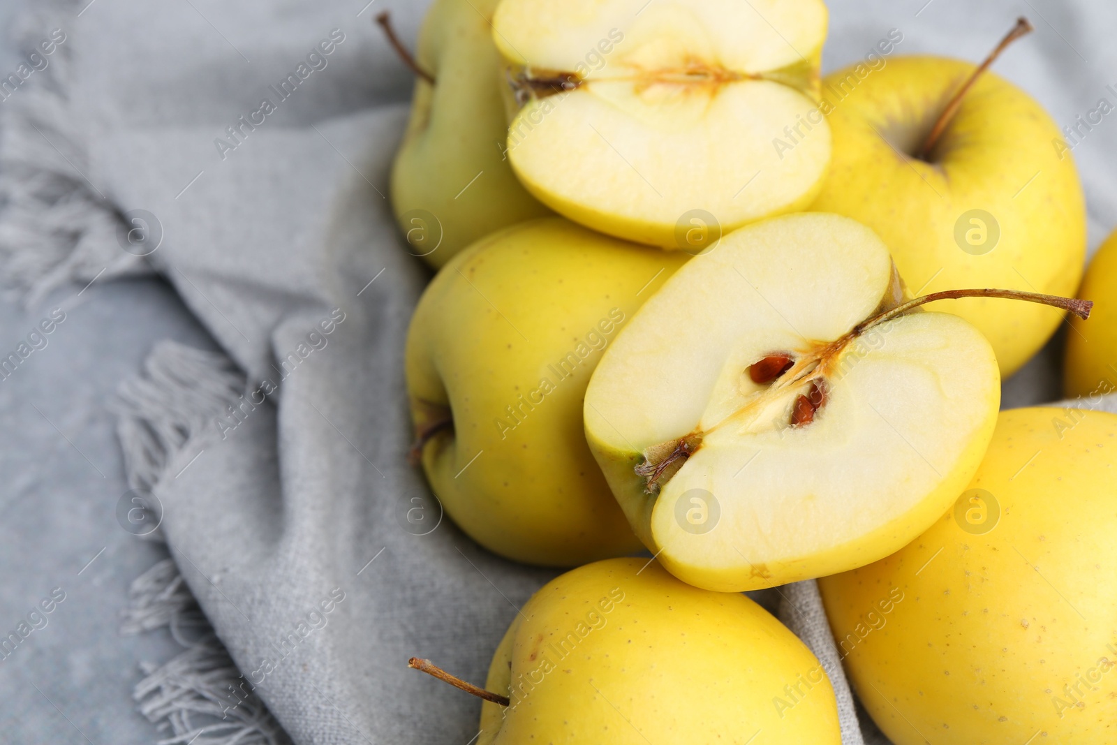 Photo of Fresh ripe yellow apples on grey table, closeup. Space for text