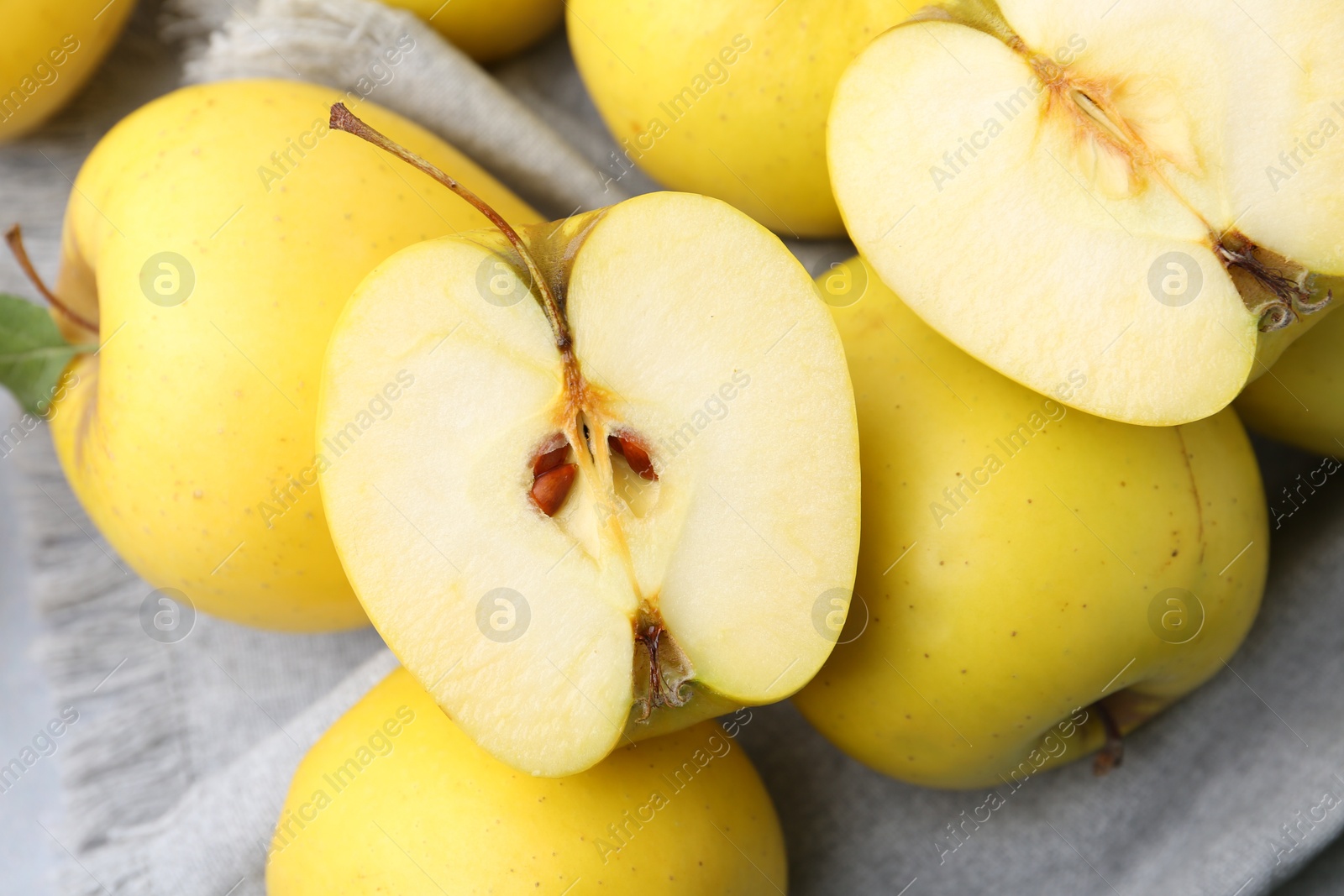 Photo of Fresh ripe yellow apples on grey table, closeup