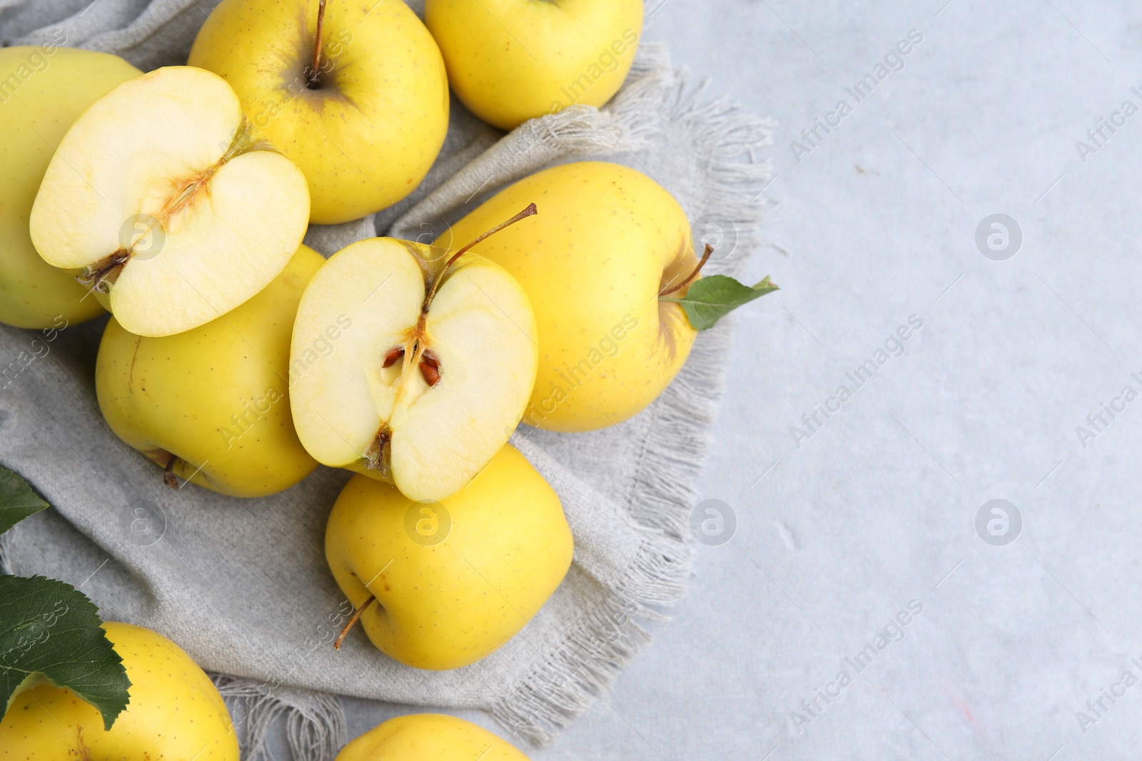 Photo of Fresh ripe yellow apples on grey table, above view. Space for text