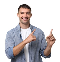 Smiling man with dental braces pointing at something on white background