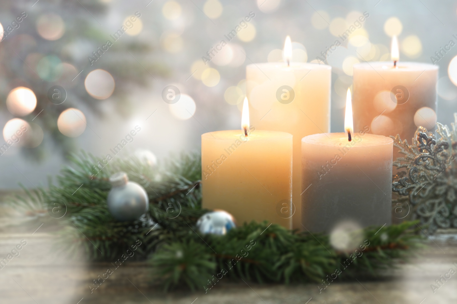 Image of Christmas composition with burning candles on wooden table, bokeh effect. Festive card