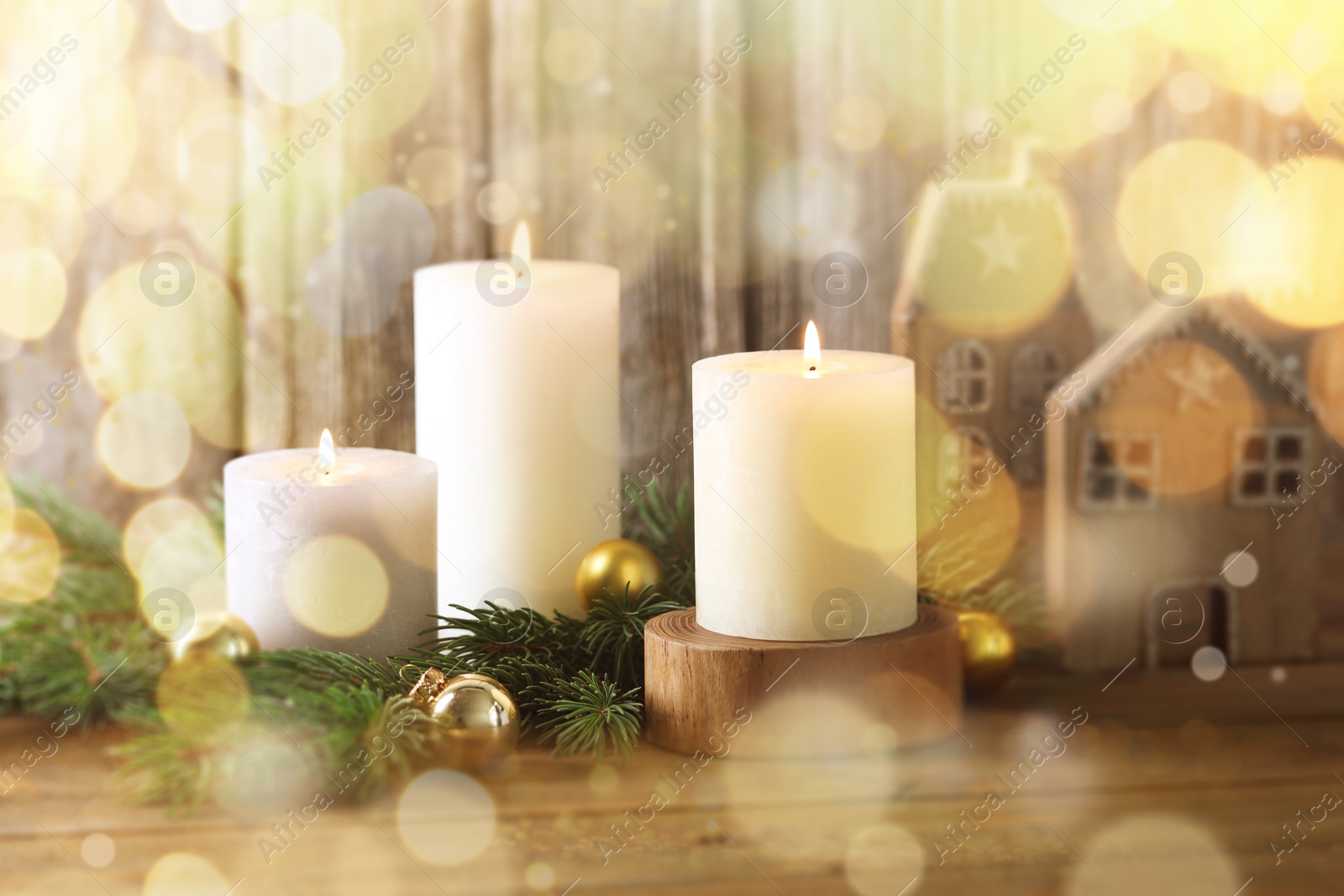 Image of Christmas composition with burning candles on wooden table, bokeh effect. Festive card