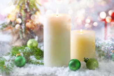 Image of Christmas composition with burning candles on snow, bokeh effect. Festive card