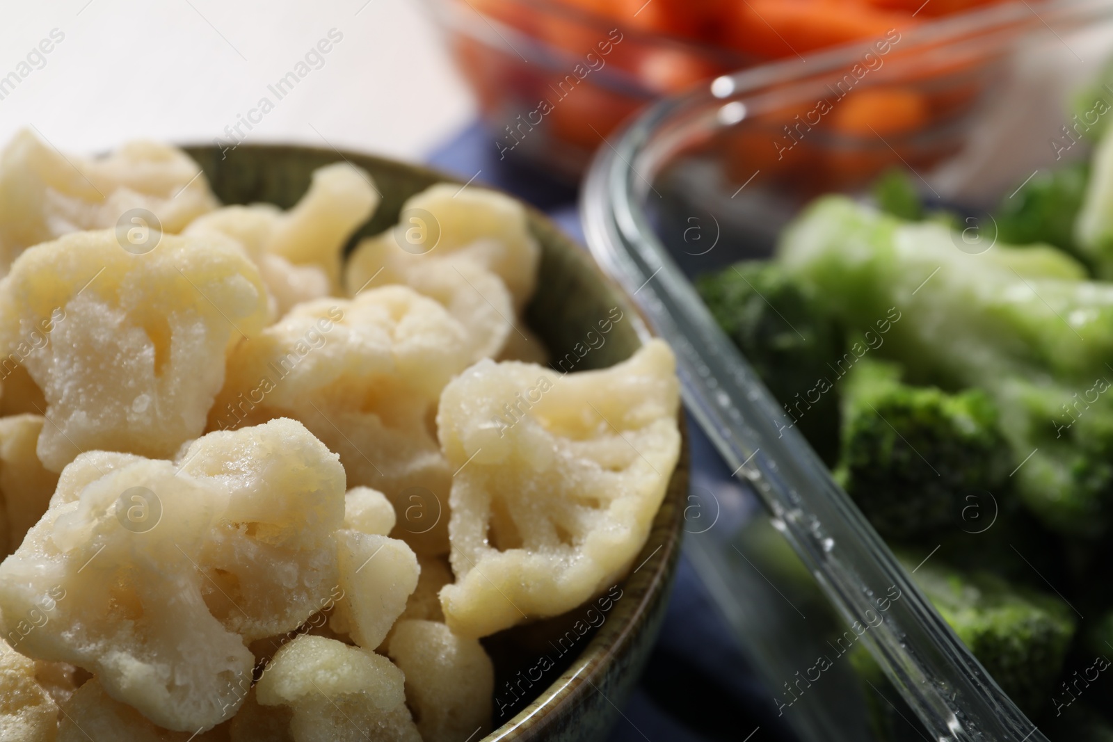 Photo of Frozen cauliflower and broccoli on table, closeup