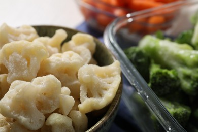 Photo of Frozen cauliflower and broccoli on table, closeup